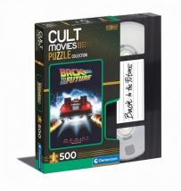 Boîte du puzzle Retour vers le futur 500 pièces de la collection Cult Movies par Clementoni, présentée dans un coffret original en forme de cassette VHS. La face avant montre la célèbre affiche du film avec la DeLorean laissant des traînées de feu sur la